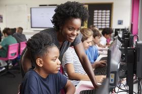 Computer science teacher with young student